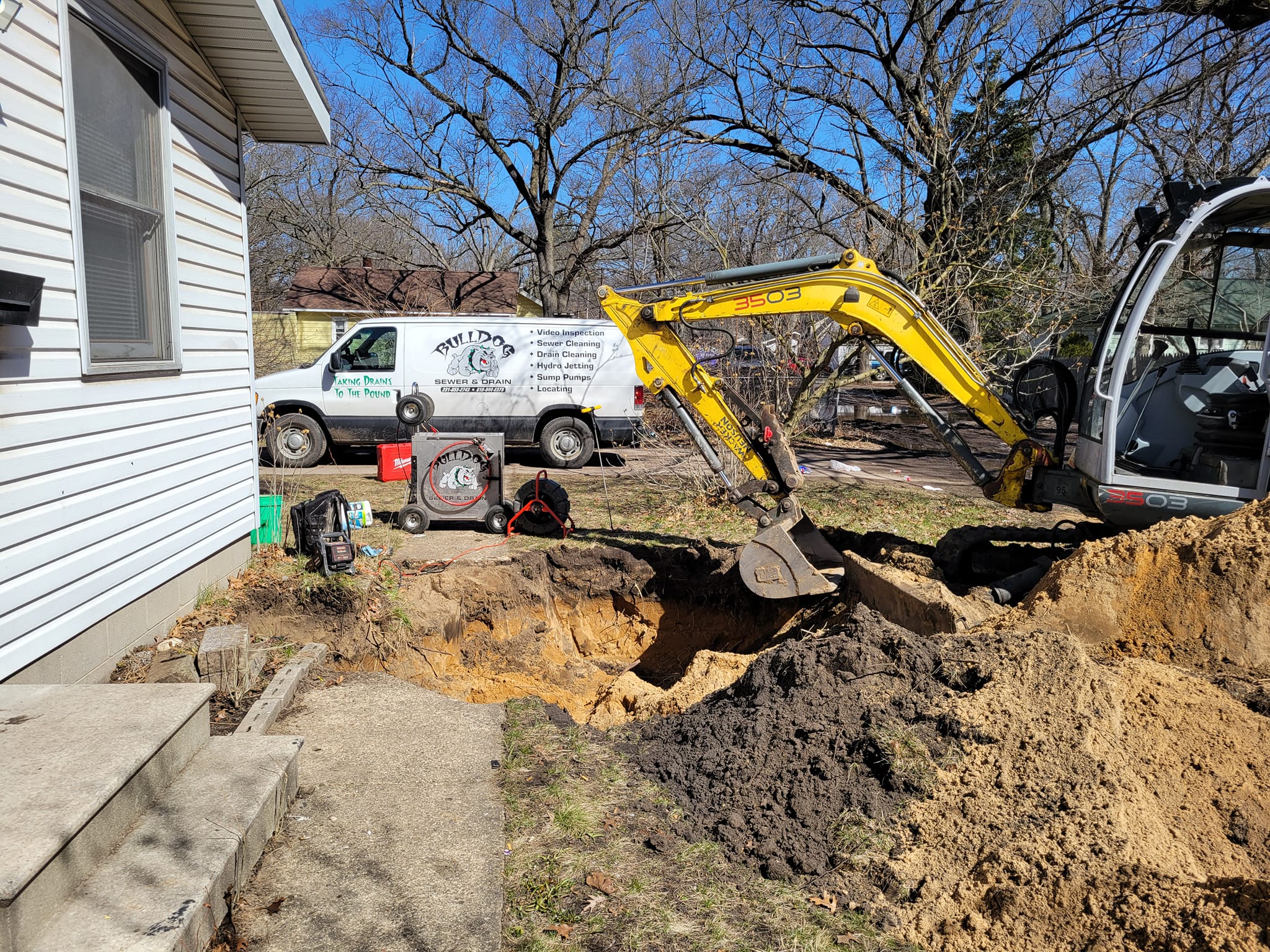 Bulldog Sewer & Drain crew excavating and repairing a sewer line at a West Michigan home